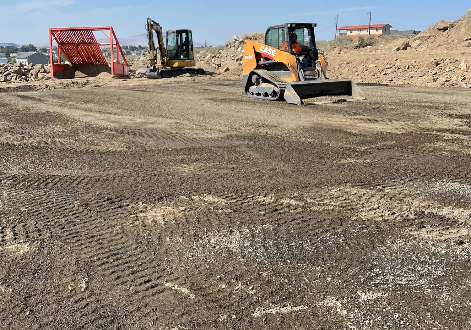 Construction site with machinery and soil preparation.